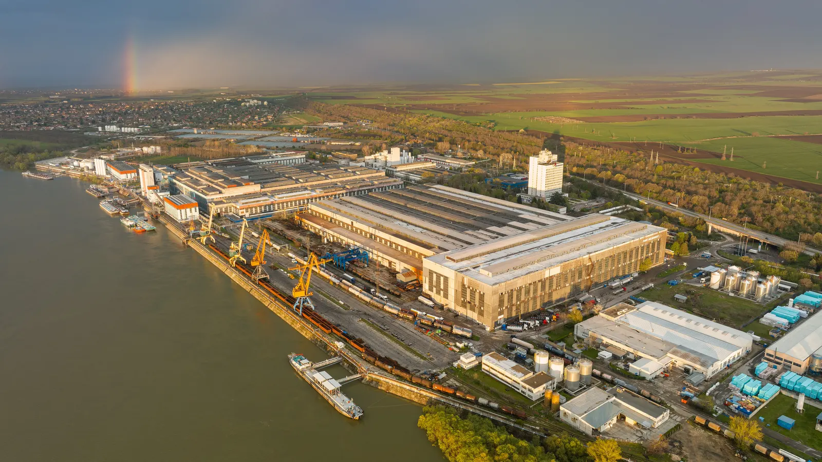The Group's site at Ruse from the air — the production halls, the quay cranes and barges on the Danube.